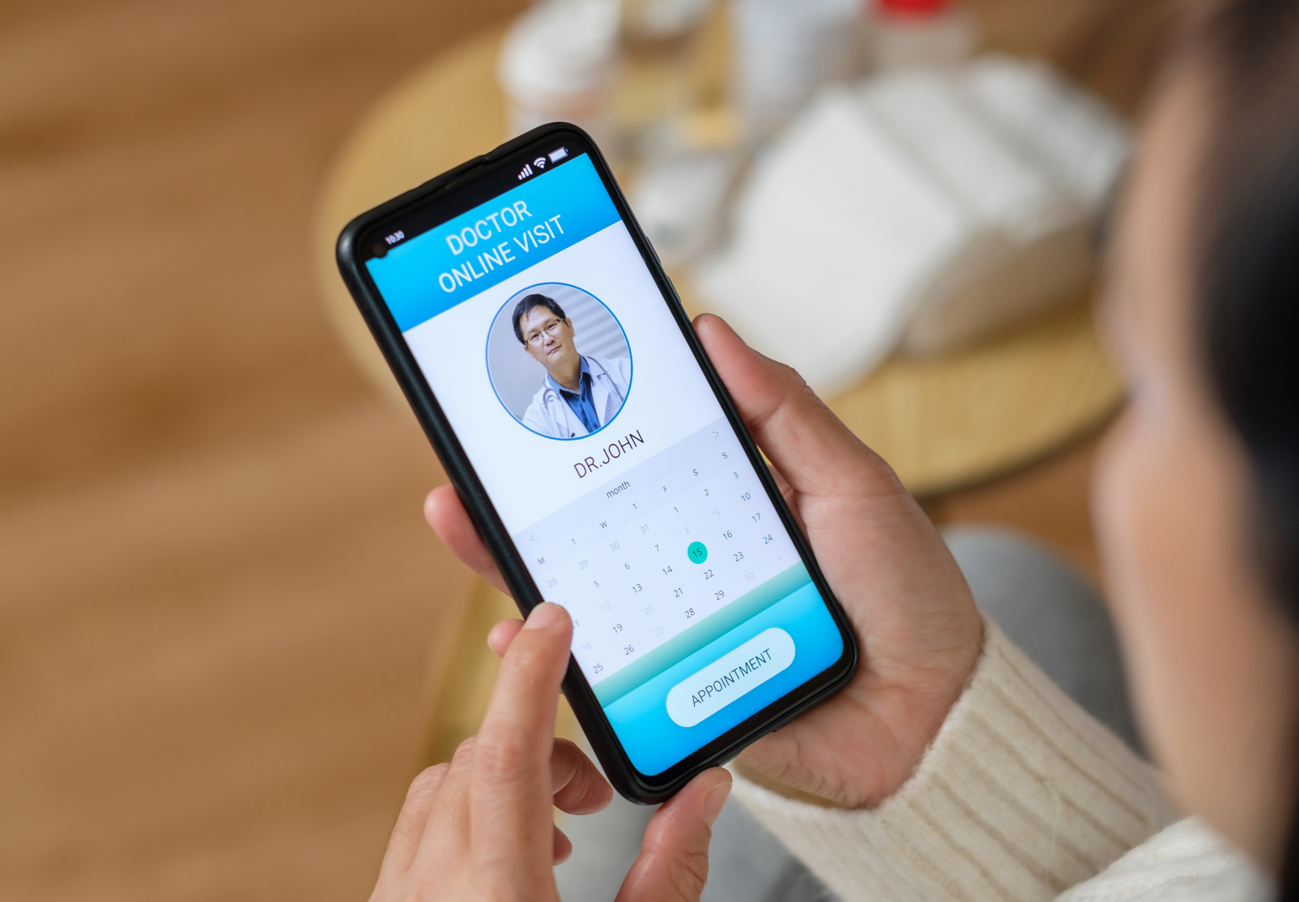 Woman booking doctor's appointment on smartphone